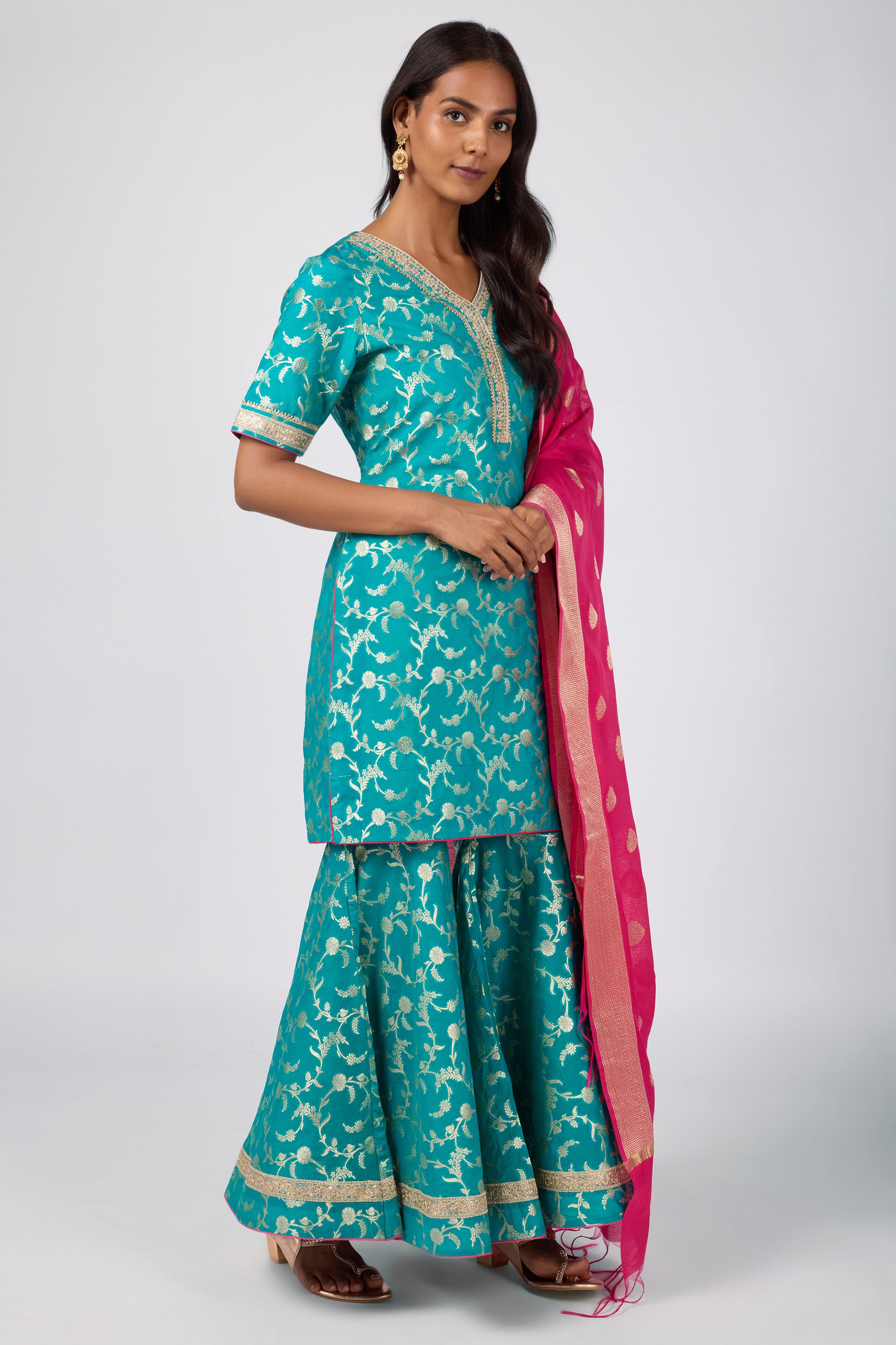 Brocade short V-neck kurti paired with sharara and dupatta.