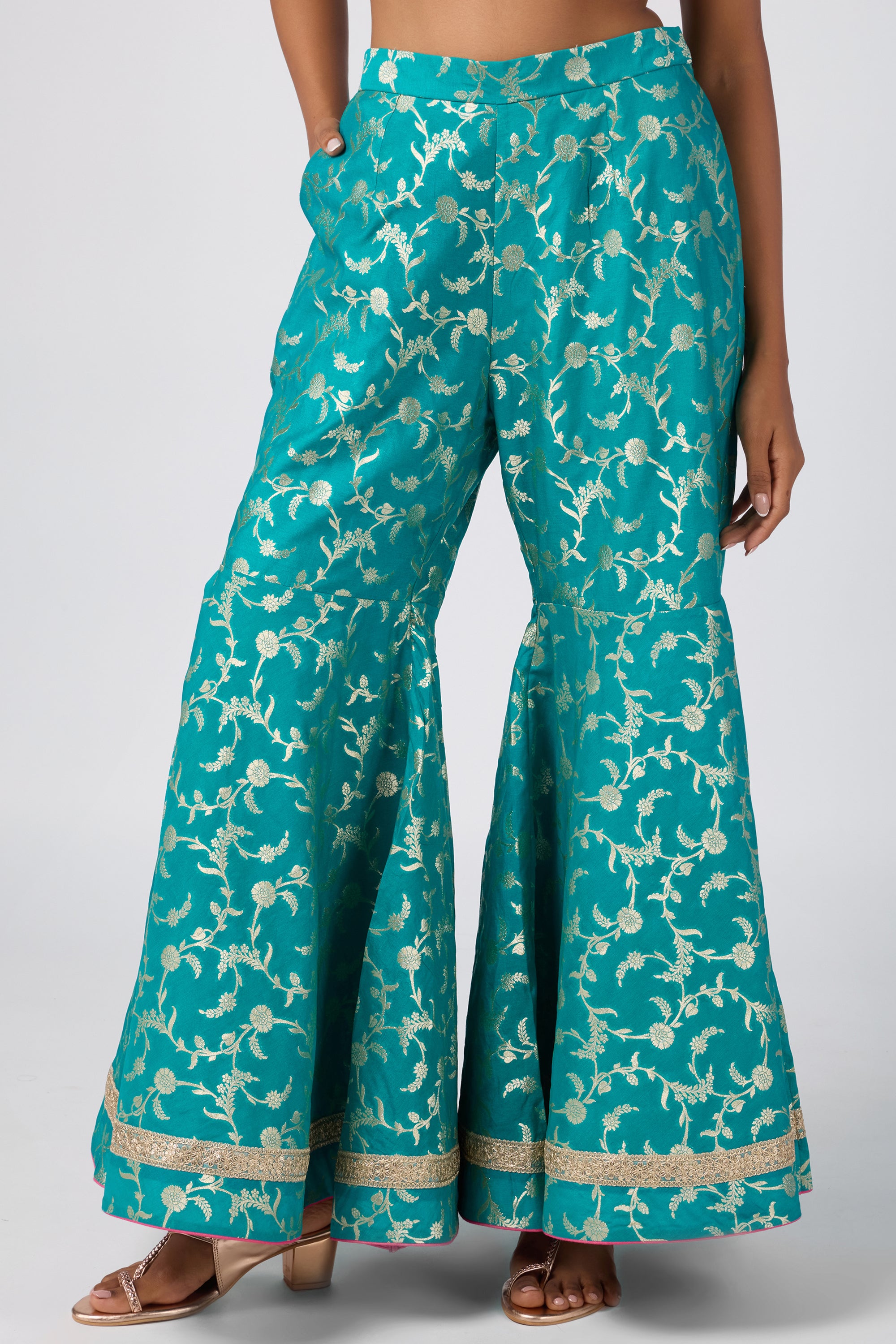 Brocade short V-neck kurti paired with sharara and dupatta.