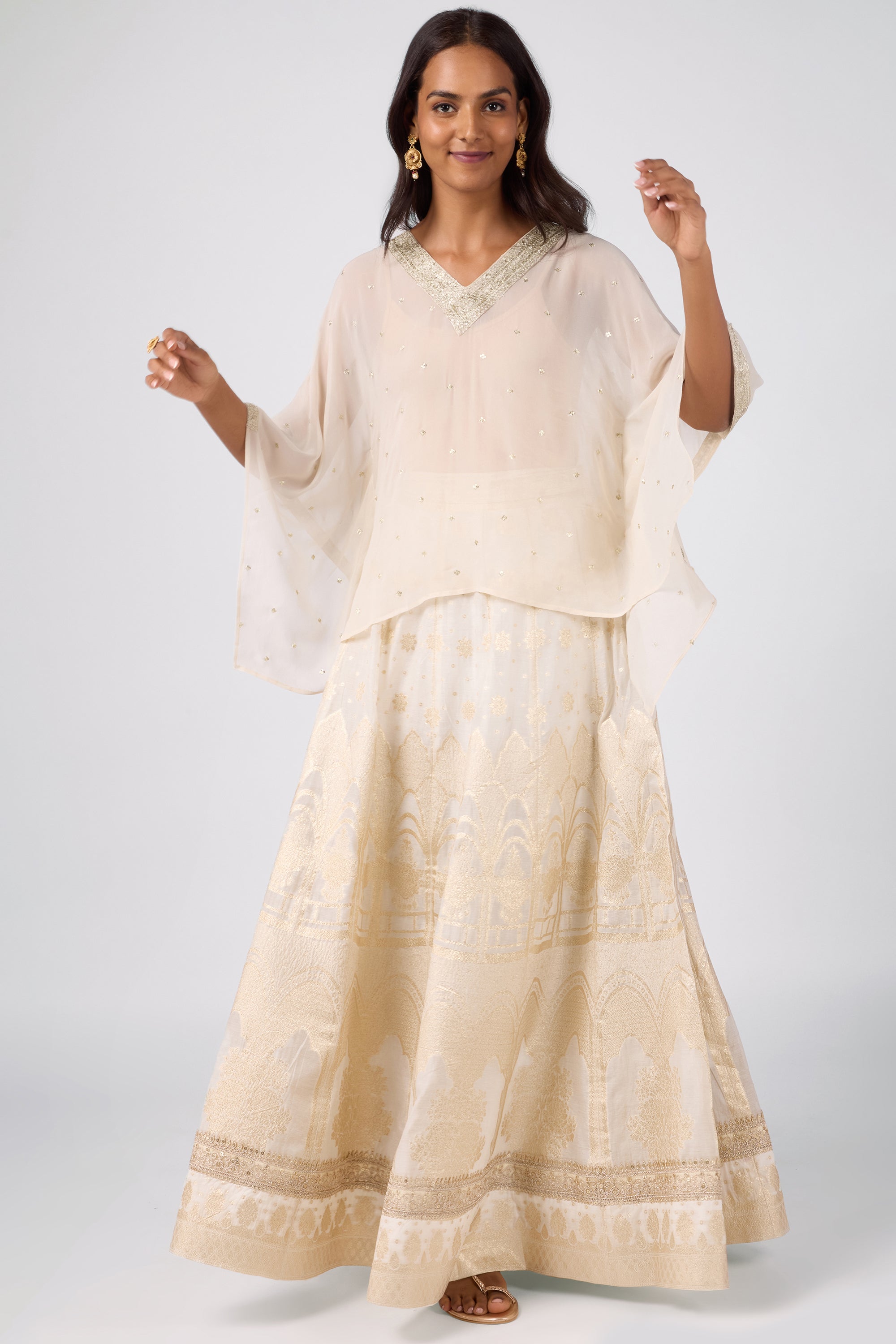 Kaftan top with delicate zari embroidery paired with a brocade skirt.