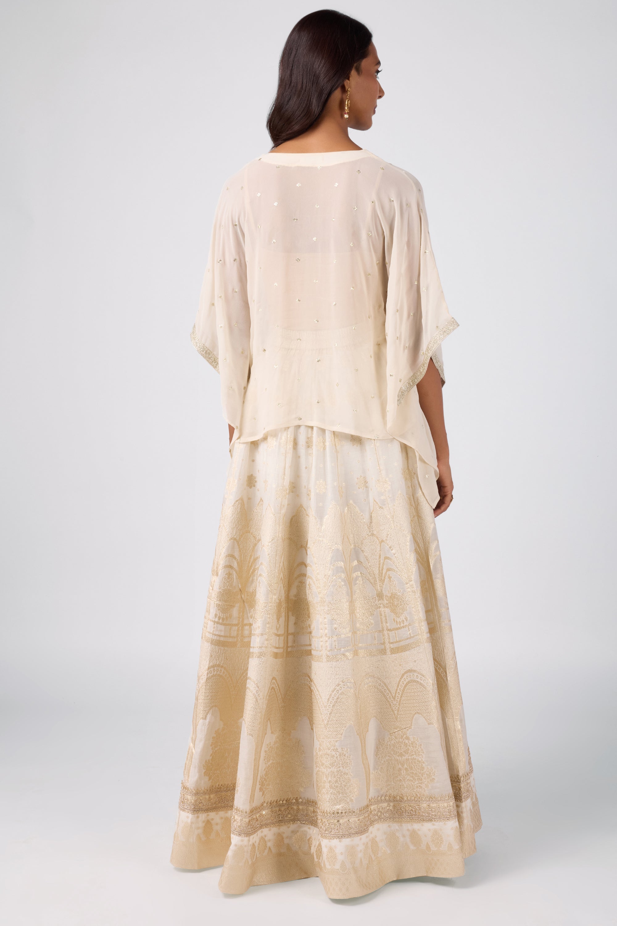 Kaftan top with delicate zari embroidery paired with a brocade skirt.