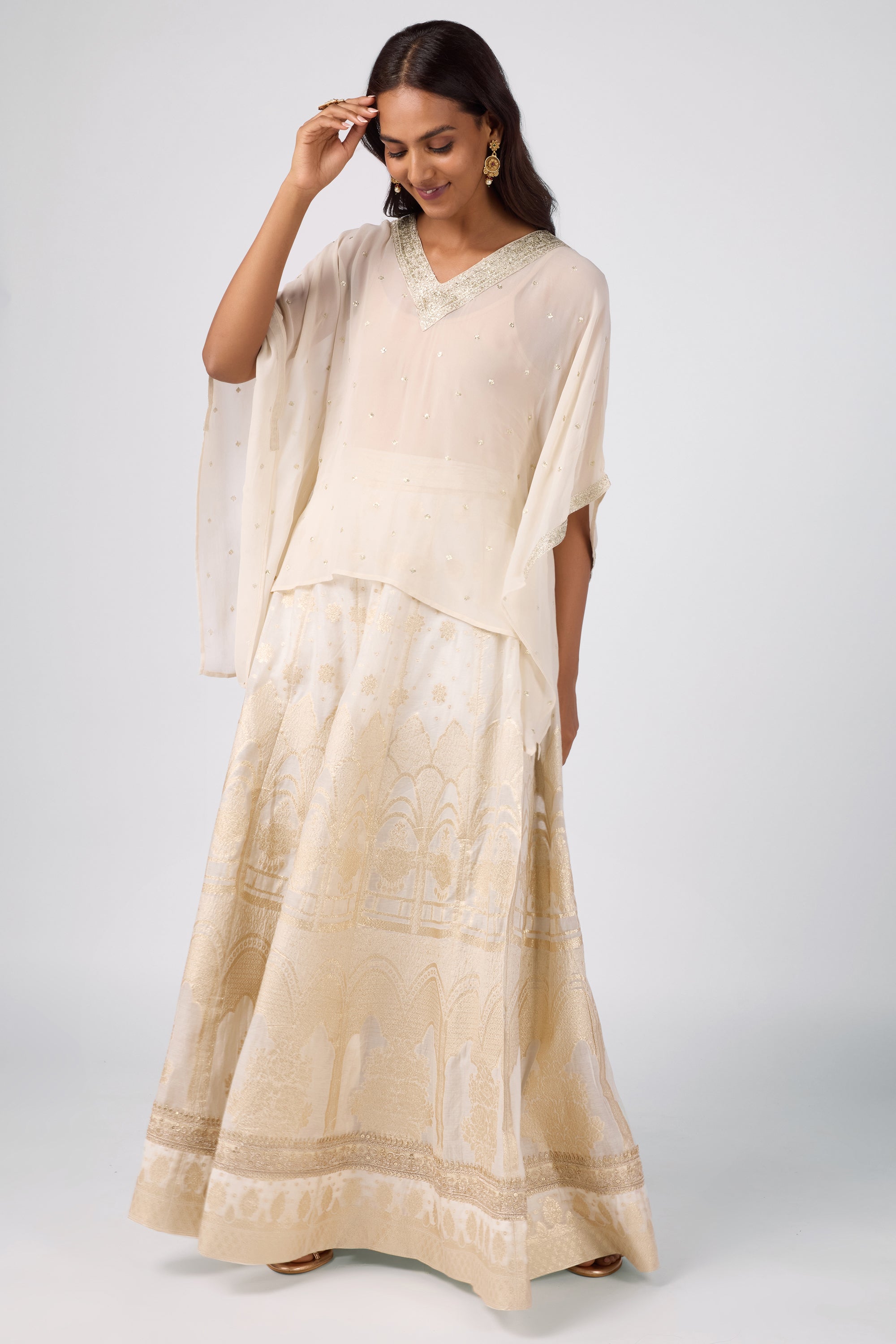 Kaftan top with delicate zari embroidery paired with a brocade skirt.