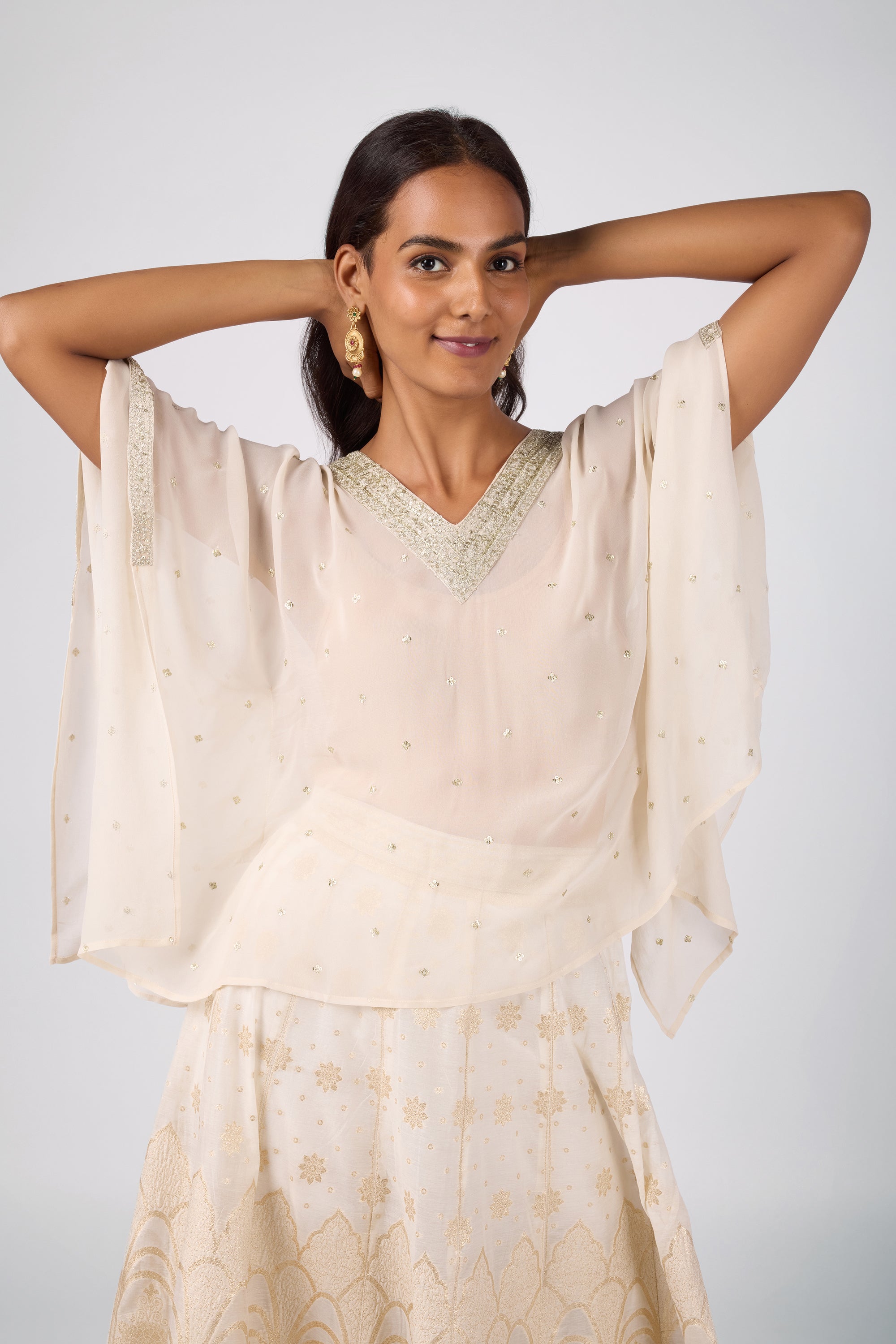 Kaftan top with delicate zari embroidery paired with a brocade skirt.